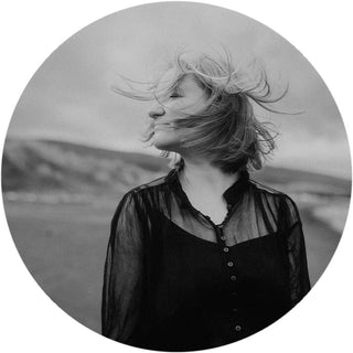 Circular black and white headshot of German equine fine art photographer Janine Ulbrich