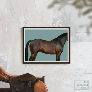 Fine art photography print of a dark bay horse against a blue background by Kate Stephenson - framed wall art mockup with saddle