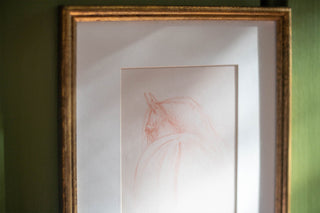 matted print of a minimalist equine sketch by Danielle Demers, framed in a vintage gold frame hanging against a green background