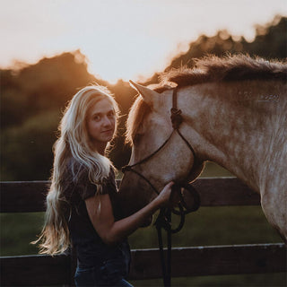 headshot of equine photographer sara ceraldi with a buckskin pony